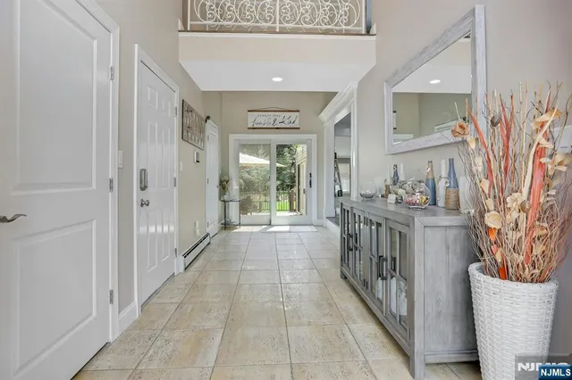 a living room with stainless steel appliances furniture and wooden floor