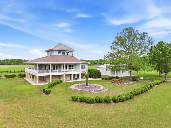 a front view of a house with a yard table and chairs