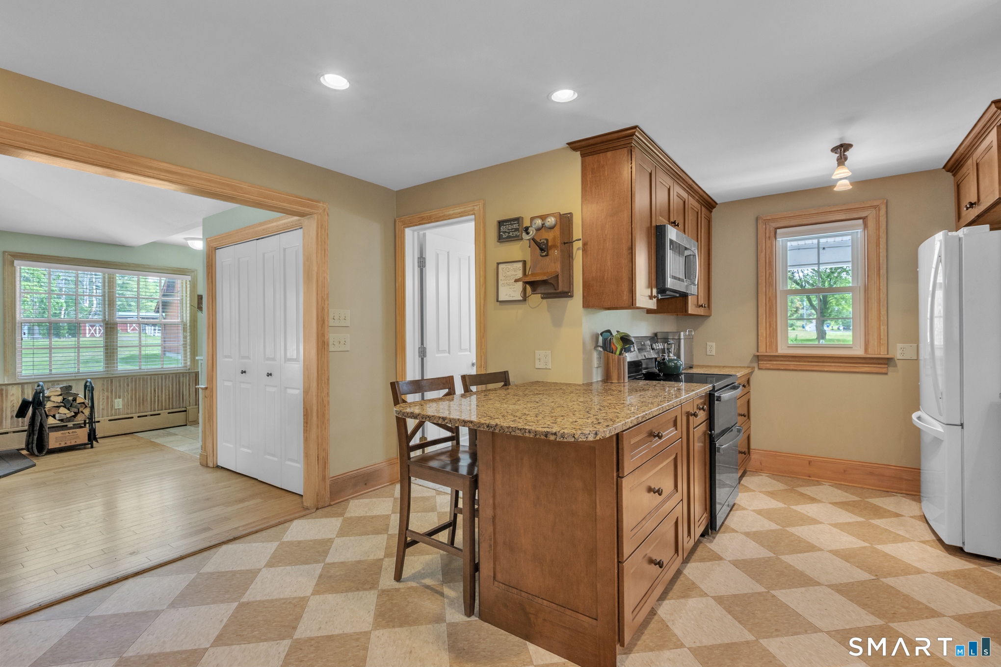 808 Branch Road Suffield, CT 06078 - Photo 8 of 40 a kitchen with granite countertop a sink and a refrigerator