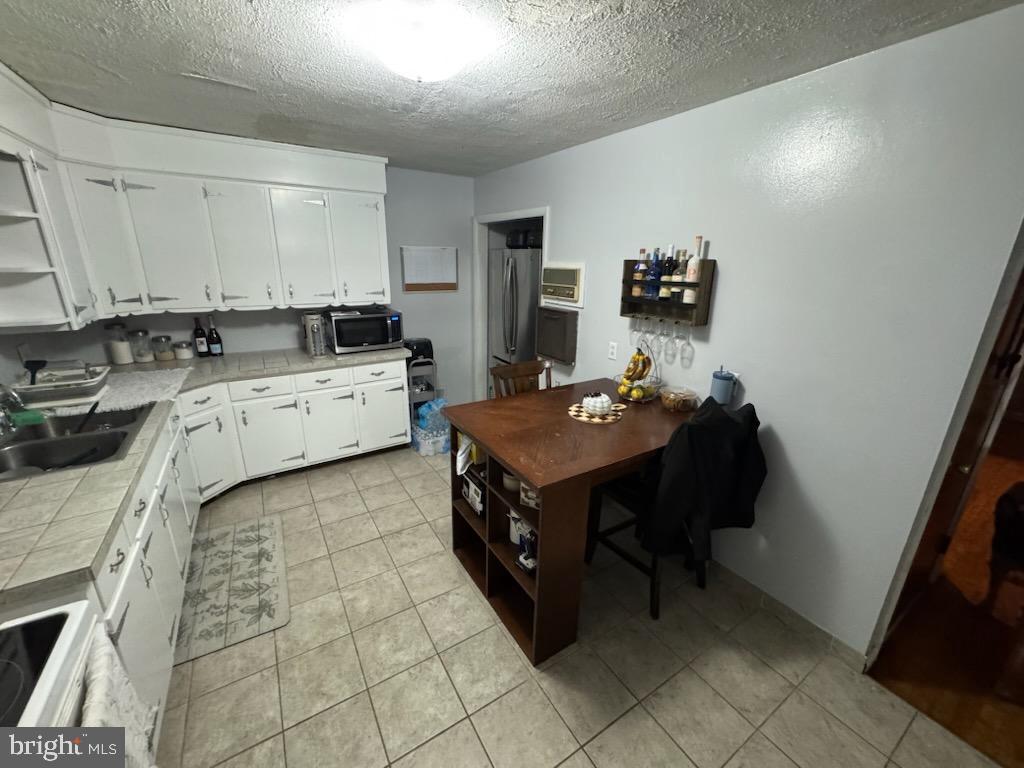 315 James Road Carlisle, PA 17013 - Photo 44 of 47 a kitchen with a stove a sink and a refrigerator