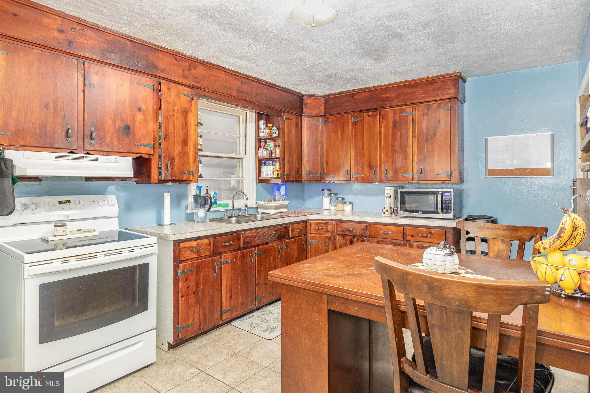 315 James Road Carlisle, PA 17013 - Photo 8 of 47 a kitchen with stainless steel appliances wooden cabinets stove and a sink