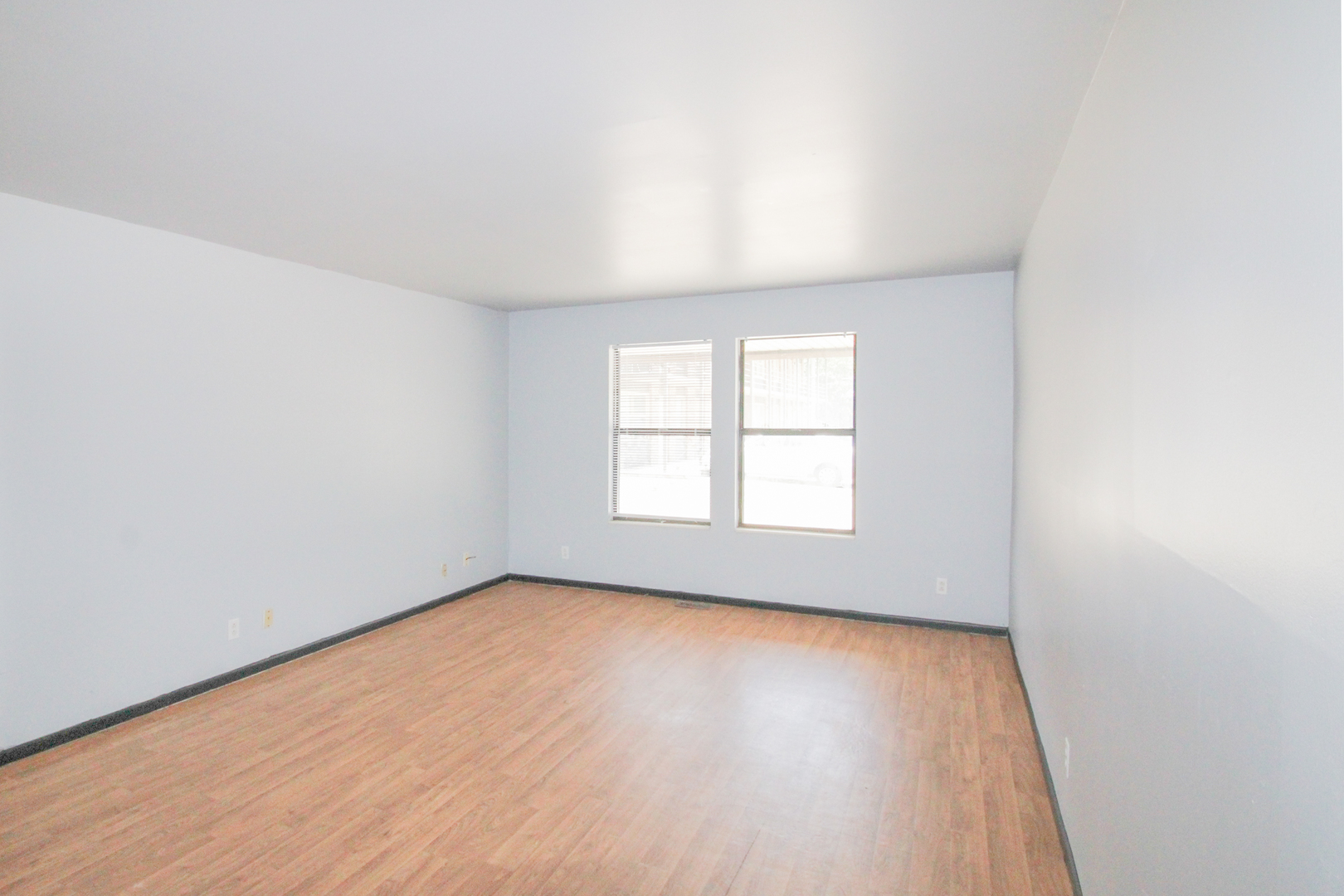 2008 Vawter Street, Unit 103 Urbana, IL 61801 - Photo 4 of 16 an empty room with wooden floor and windows