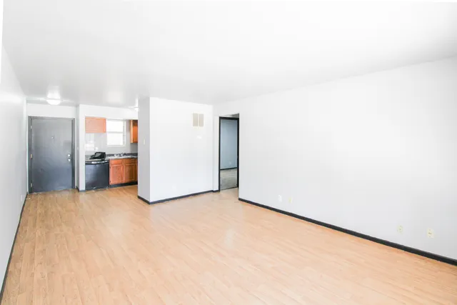 a view of empty room with kitchen