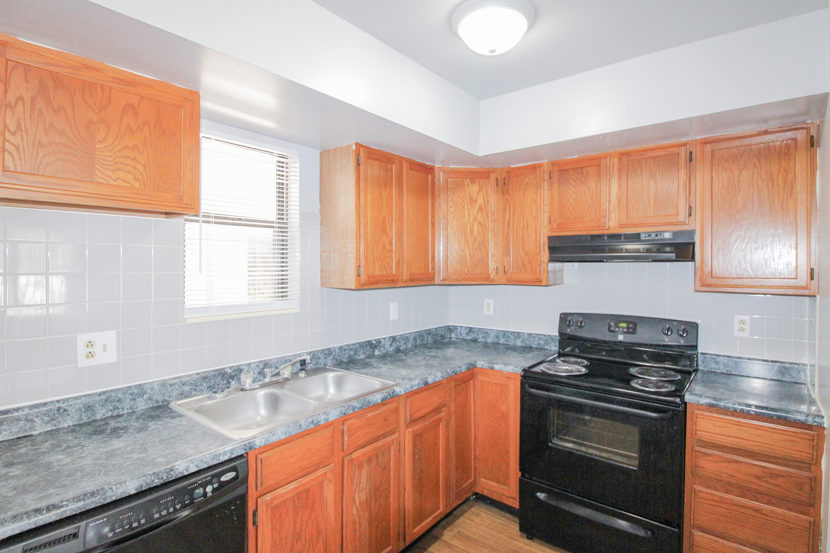2008 Vawter Street, Unit 103 Urbana, IL 61801 - Photo 8 of 16 a kitchen with granite countertop a sink a stove and cabinets
