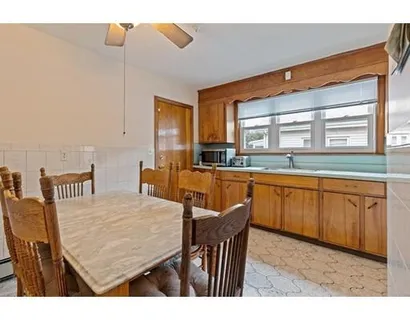 a kitchen with a table and chairs in it
