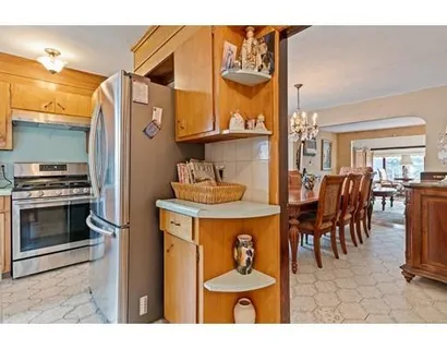a kitchen with stainless steel appliances kitchen island granite countertop a table and chairs
