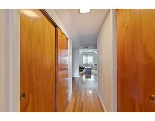 41 Bailey Road Somerville, MA 02145 - Photo 28 of 32 a open cabinet with chair and glass door