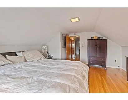 a bedroom with a bed and a mirror