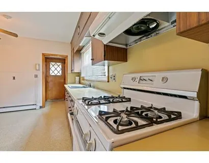a kitchen with a stove and a refrigerator