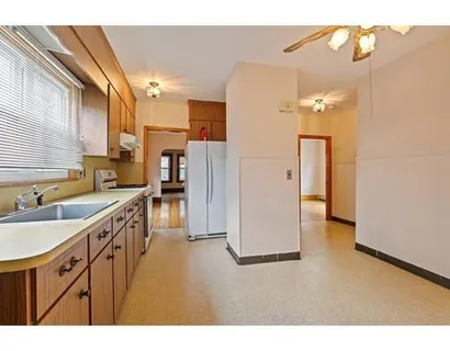 a kitchen with a sink appliances and cabinets