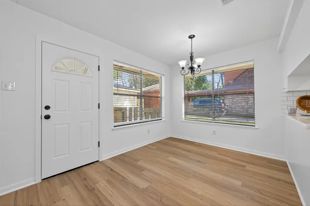 a very nice looking room with a window and a chandelier