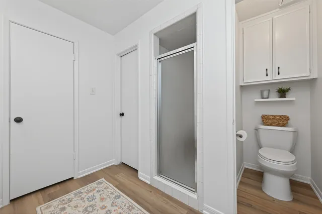 a bathroom with a toilet and a shower