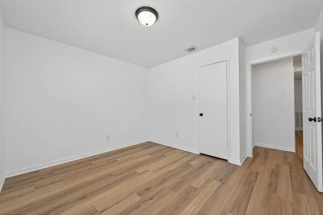 a view of a room with wooden floor
