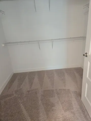 a view of a refrigerator in white kitchen