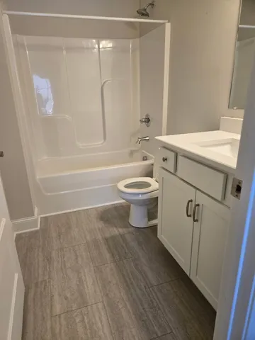 a bathroom with a toilet a sink and bathtub