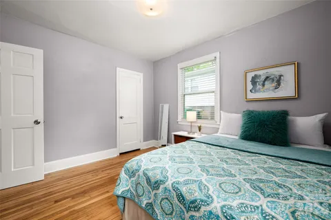 a bedroom with a large bed and a window