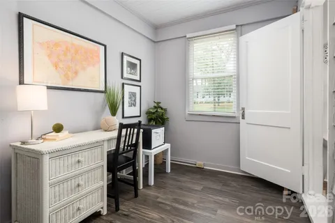 a view of a room that has a window and a dresser in it