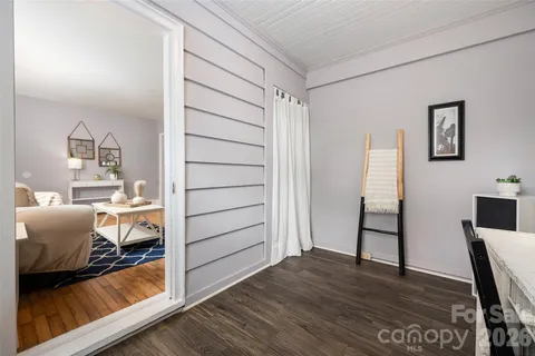 a view of a bedroom with wooden floor and bedroom