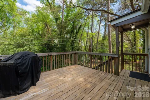 a balcony with wooden floor and fence