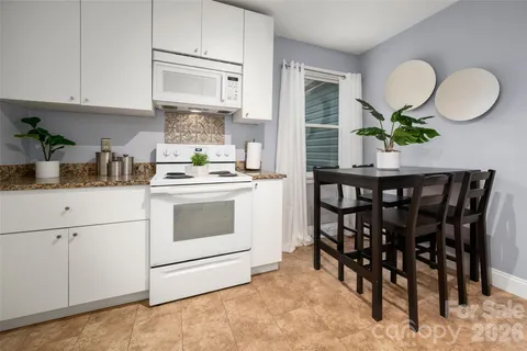 a kitchen with a white cabinets and white appliances
