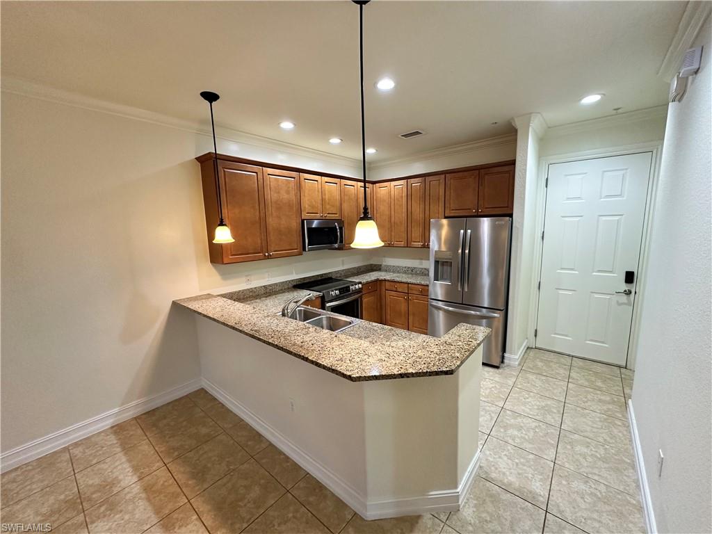 9147 Delano Street, Unit 9605 Naples, FL 34113 - Photo 2 of 27 a kitchen with stainless steel appliances granite countertop a sink a stove a refrigerator and island