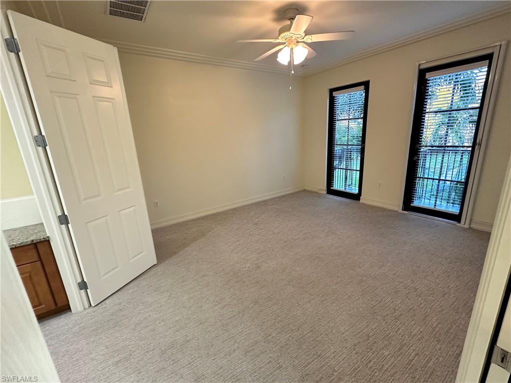 9147 Delano Street, Unit 9605 Naples, FL 34113 - Photo 7 of 27 an empty room with windows and entrance