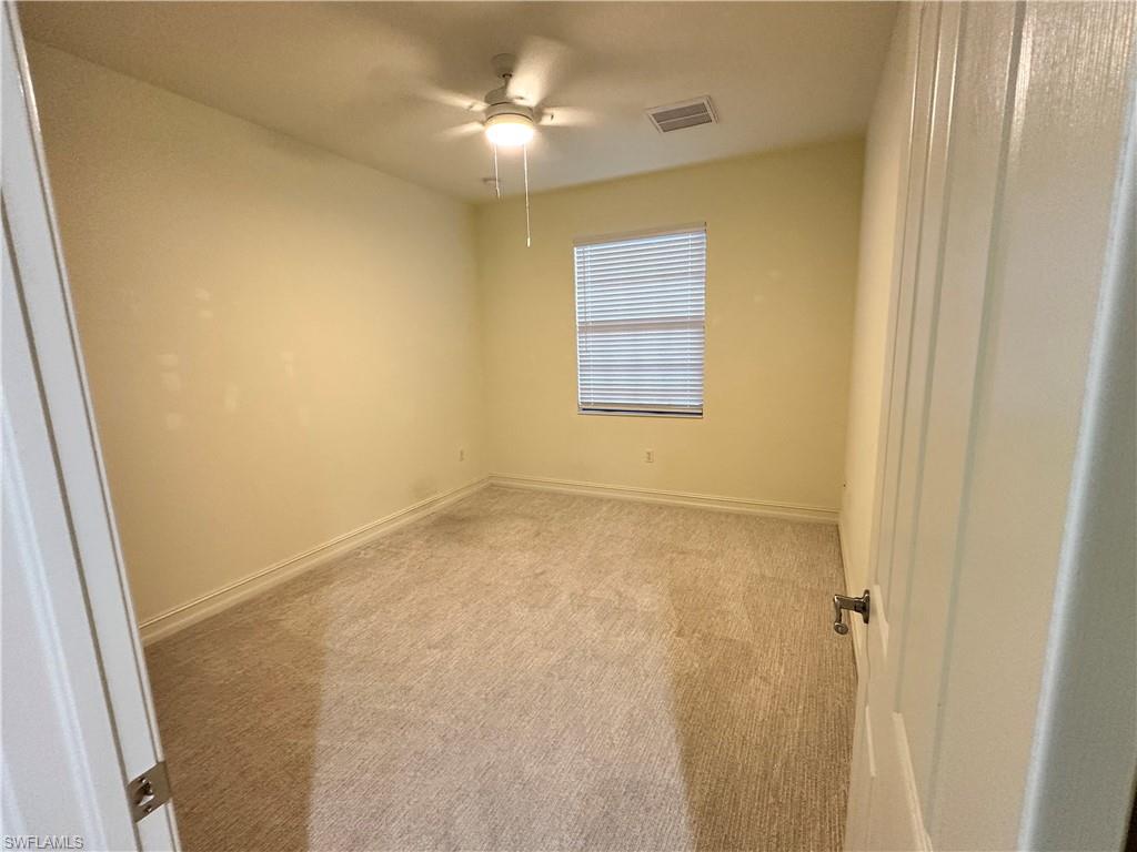 9147 Delano Street, Unit 9605 Naples, FL 34113 - Photo 10 of 27 a view of an empty room with a window