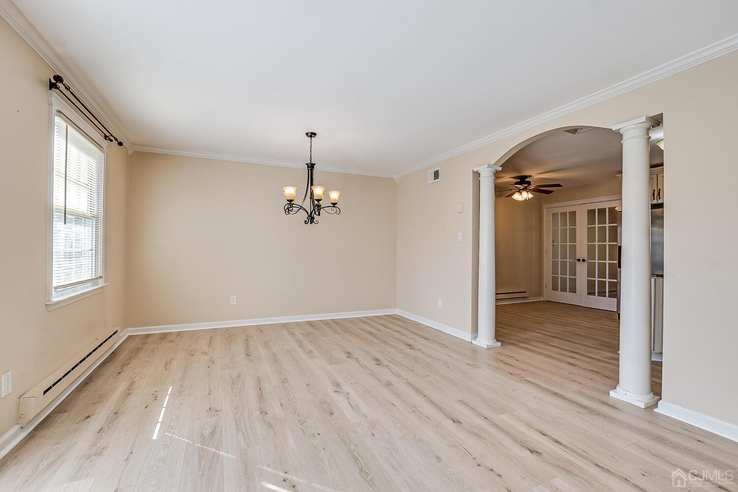 85 Jamestown Road, Unit B Freehold, NJ 07728 - Photo 13 of 36 wooden floor in an empty room with a window