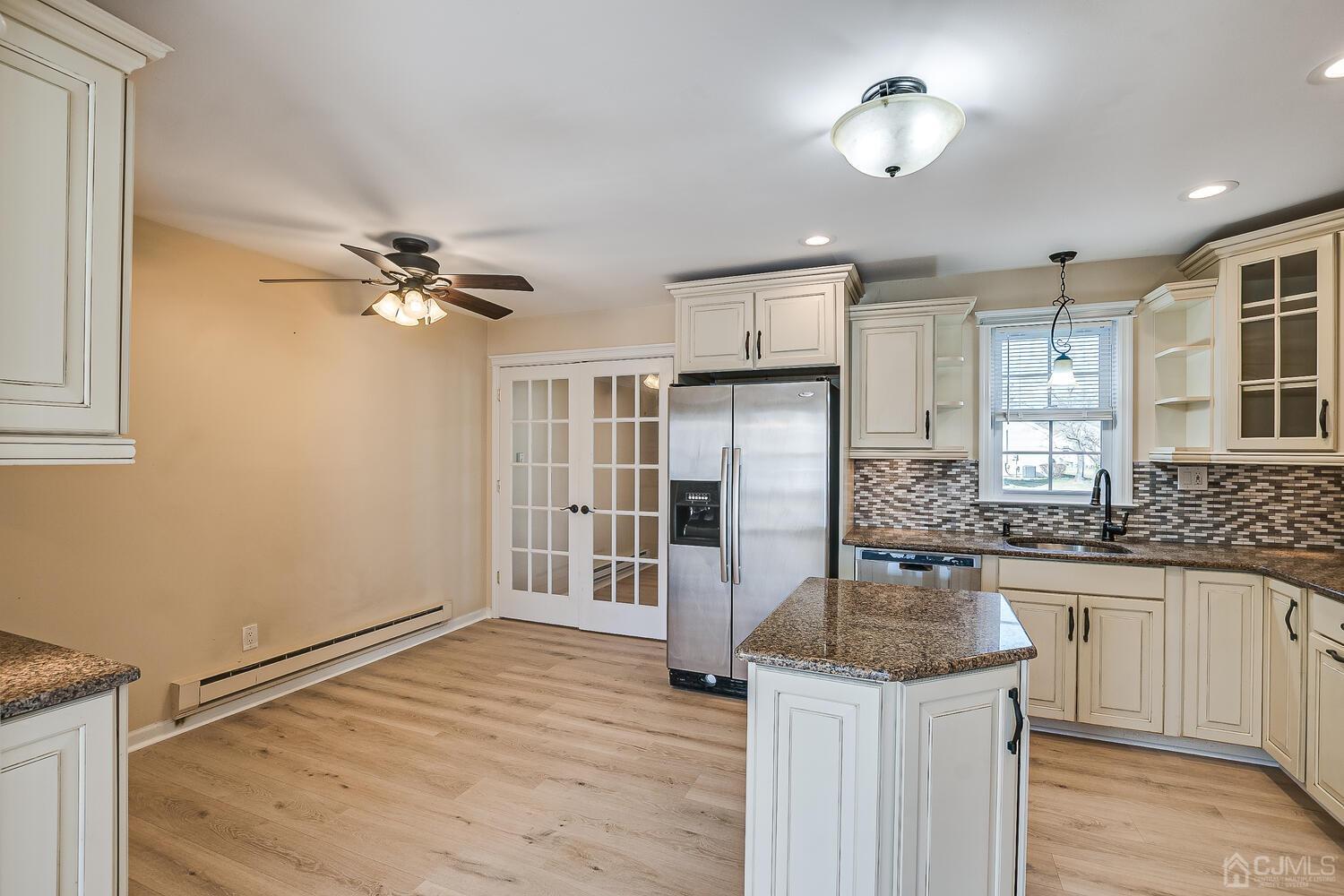 85 Jamestown Road, Unit B Freehold, NJ 07728 - Photo 16 of 36 a kitchen with stainless steel appliances granite countertop a sink and refrigerator