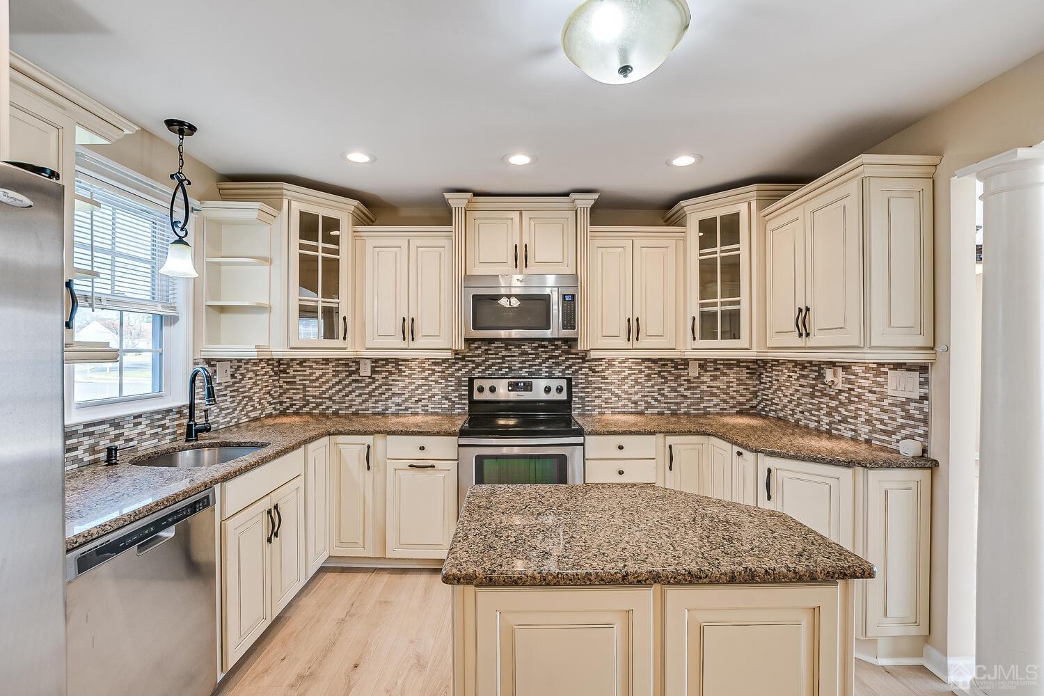 85 Jamestown Road, Unit B Freehold, NJ 07728 - Photo 18 of 36 a kitchen with stainless steel appliances granite countertop a sink and stove