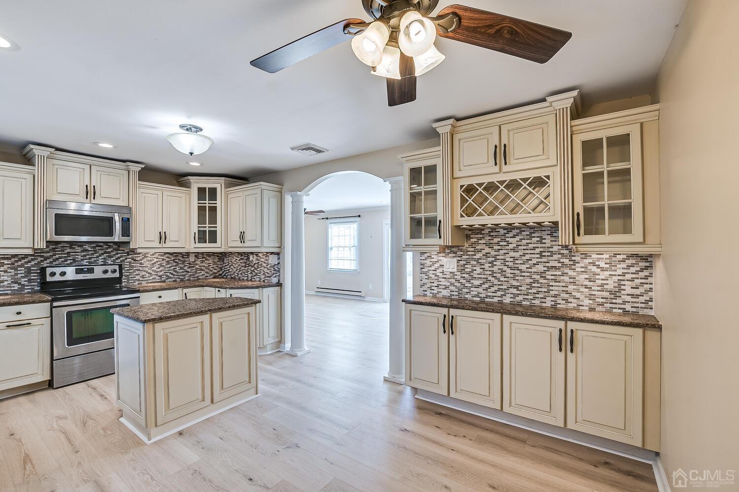 85 Jamestown Road, Unit B Freehold, NJ 07728 - Photo 21 of 36 a kitchen with stainless steel appliances granite countertop a stove and cabinets