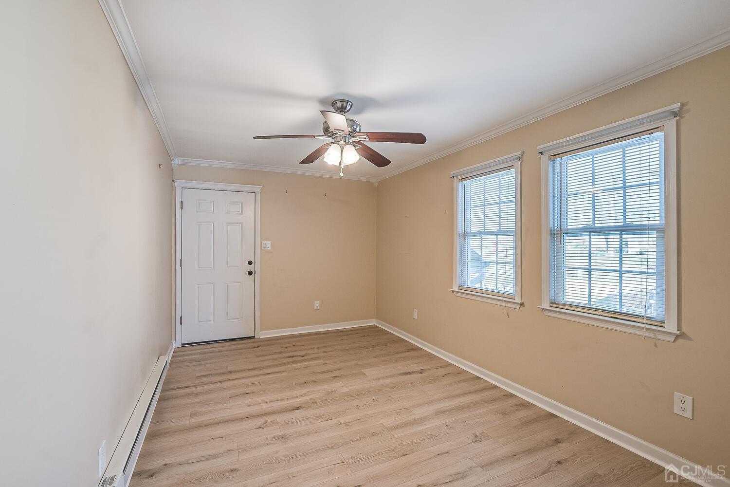 85 Jamestown Road, Unit B Freehold, NJ 07728 - Photo 23 of 36 wooden floor in an empty room with a window