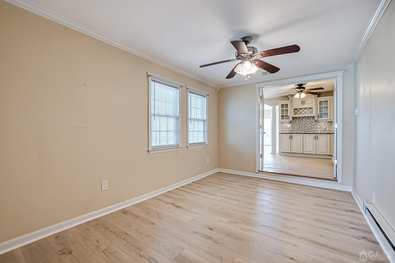 85 Jamestown Road, Unit B Freehold, NJ 07728 - Photo 24 of 36 a view of an empty room with wooden floor and a window