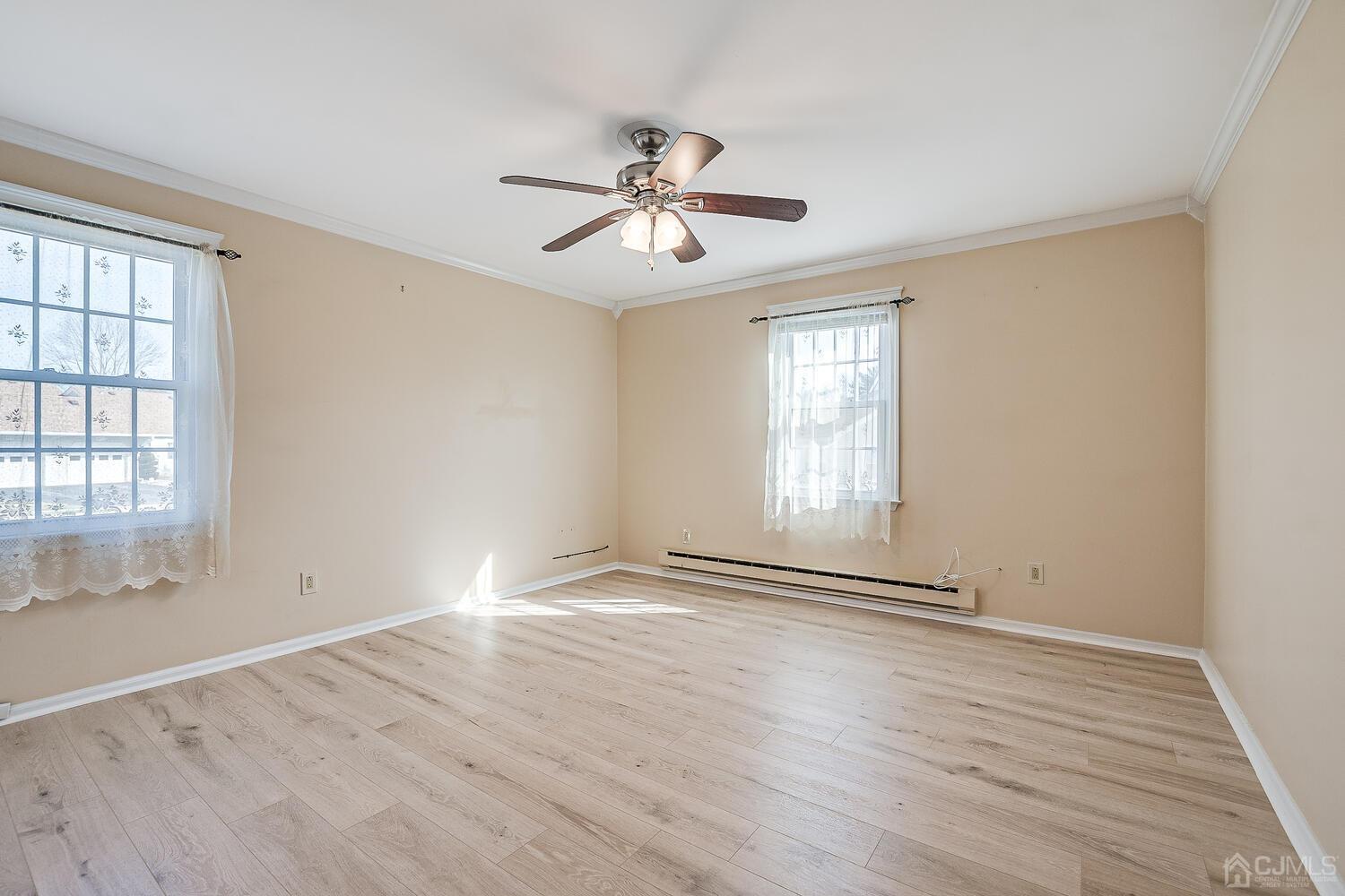 85 Jamestown Road, Unit B Freehold, NJ 07728 - Photo 25 of 36 wooden floor in an empty room with a window