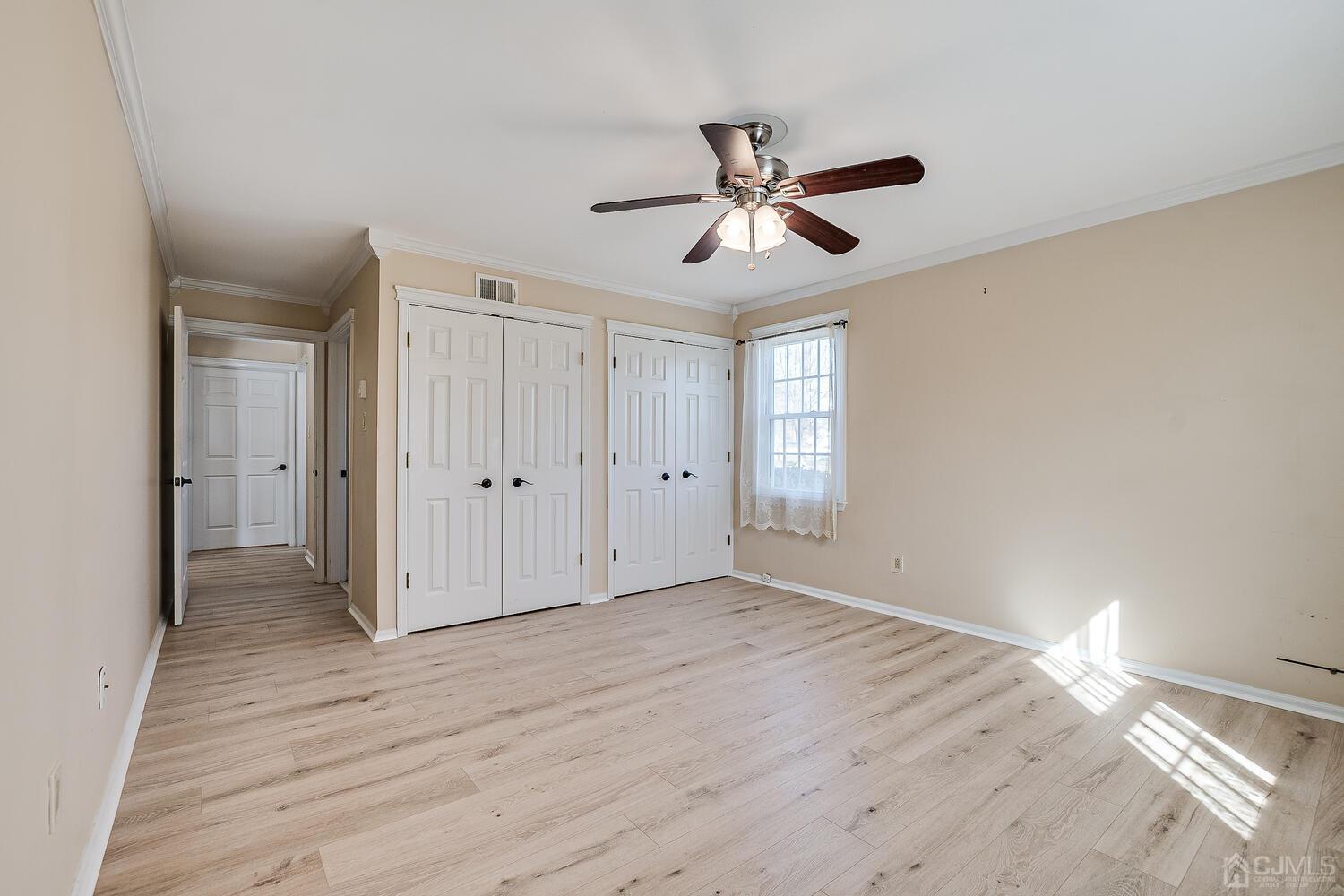 85 Jamestown Road, Unit B Freehold, NJ 07728 - Photo 26 of 36 a view of empty room with wooden floor and window