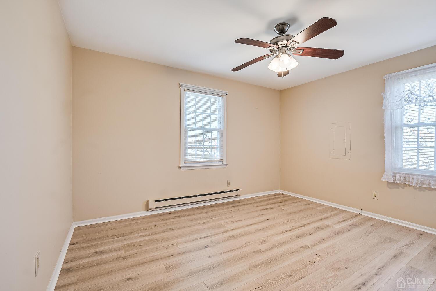 85 Jamestown Road, Unit B Freehold, NJ 07728 - Photo 28 of 36 wooden floor in an empty room with a window