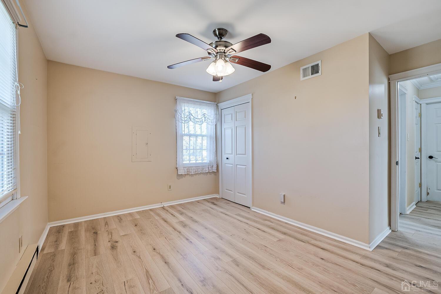 85 Jamestown Road, Unit B Freehold, NJ 07728 - Photo 29 of 36 wooden floor in an empty room with a window