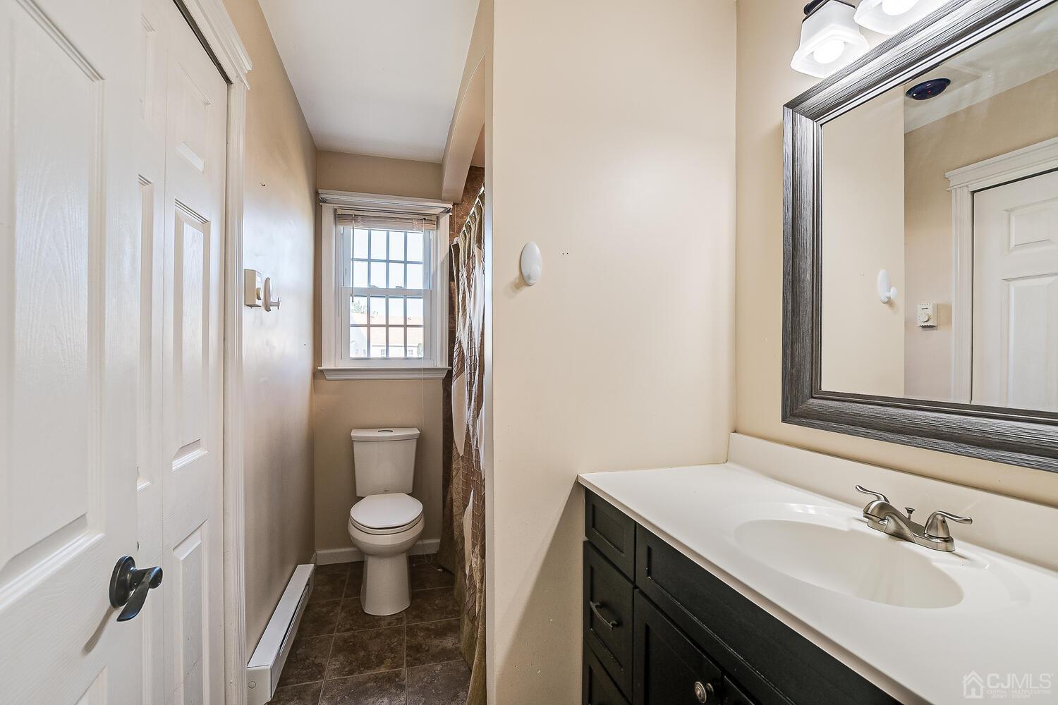 85 Jamestown Road, Unit B Freehold, NJ 07728 - Photo 30 of 36 a bathroom with a sink a toilet and shower