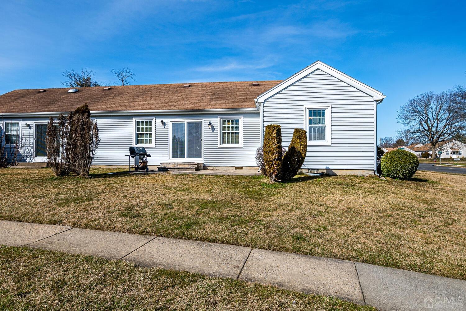 85 Jamestown Road, Unit B Freehold, NJ 07728 - Photo 33 of 36 a view of a house with a yard