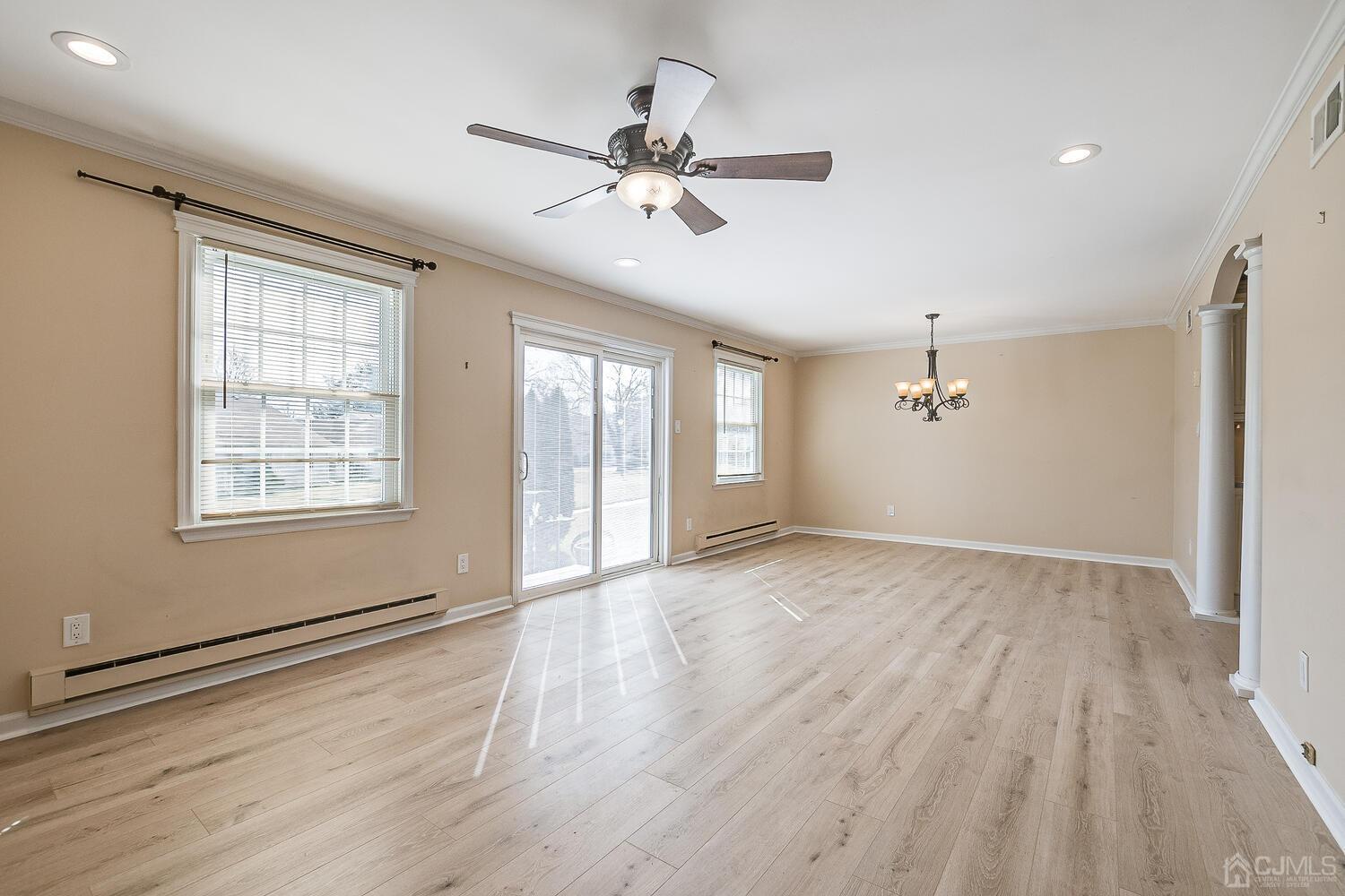 85 Jamestown Road, Unit B Freehold, NJ 07728 - Photo 9 of 36 an empty room with wooden floor fan and windows