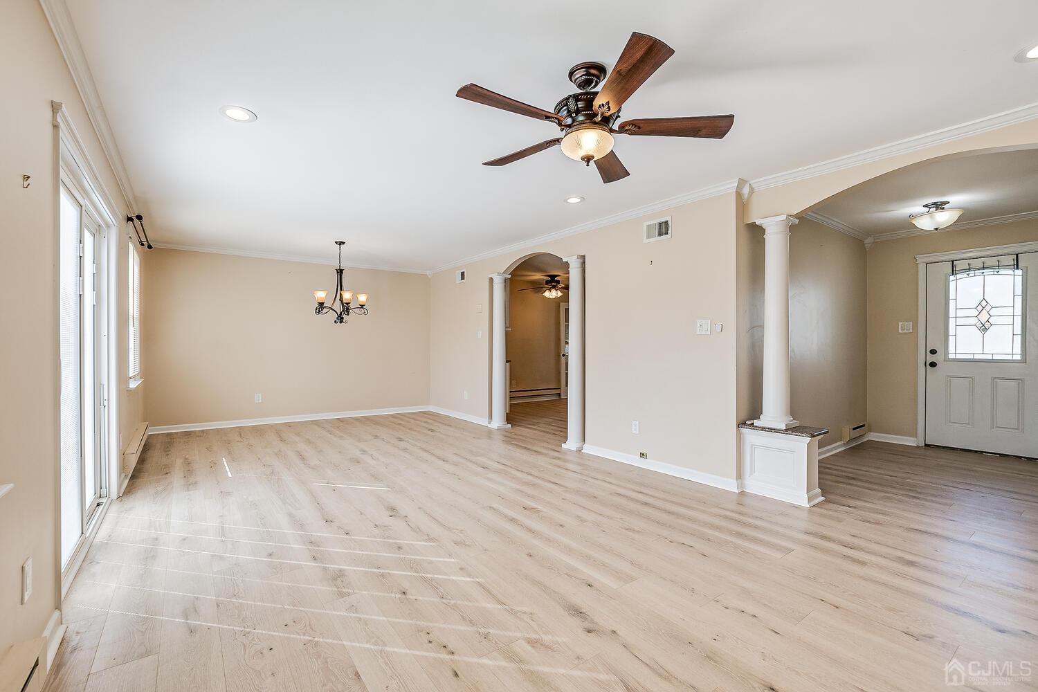 85 Jamestown Road, Unit B Freehold, NJ 07728 - Photo 10 of 36 an empty room with wooden floor and windows