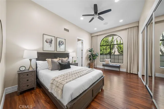 a bedroom with a large bed and a large window