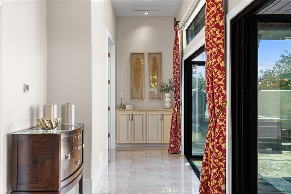 2487 Cliff Road Upland, CA 91784 - Photo 21 of 49 a view of a hallway with a dining table & chairs