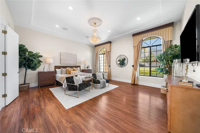 a living room with furniture a flat screen tv and a large window