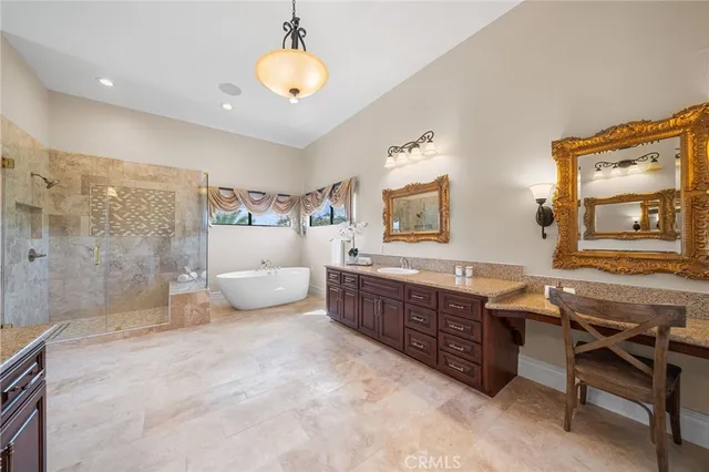 a spacious bathroom with a granite countertop tub sink and mirror