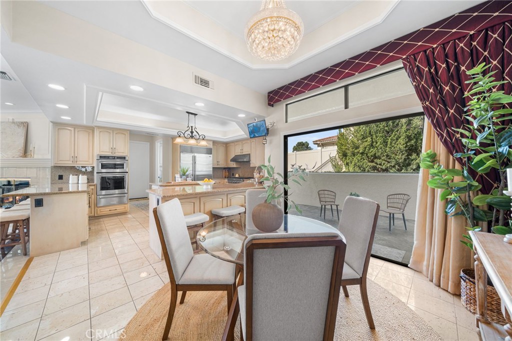 2487 Cliff Road Upland, CA 91784 - Photo 26 of 49 a dining room with furniture a kitchen view and a large window