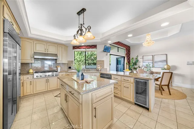 a kitchen with a stove cabinets and chairs