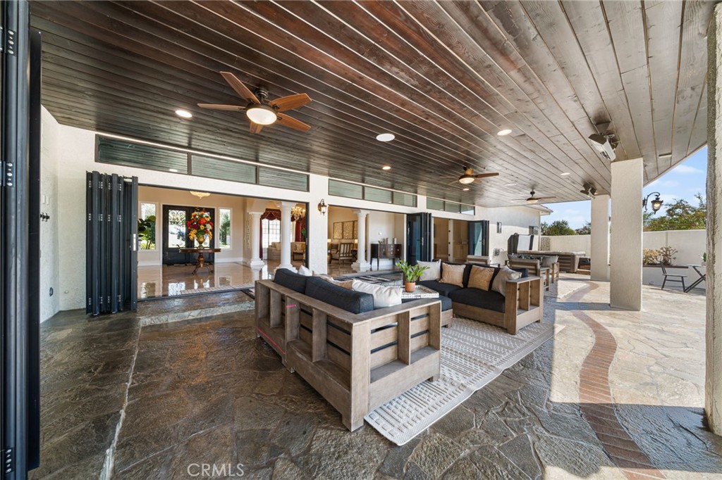 2487 Cliff Road Upland, CA 91784 - Photo 36 of 49 a view of a patio with table and chairs with wooden floor and fence