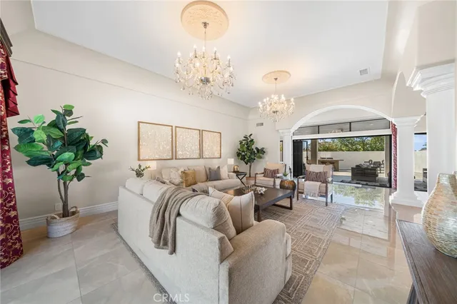 a living room with furniture a chandelier and a chandelier