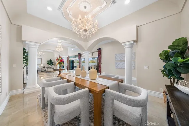 a very nice looking dining room with a table and chandelier